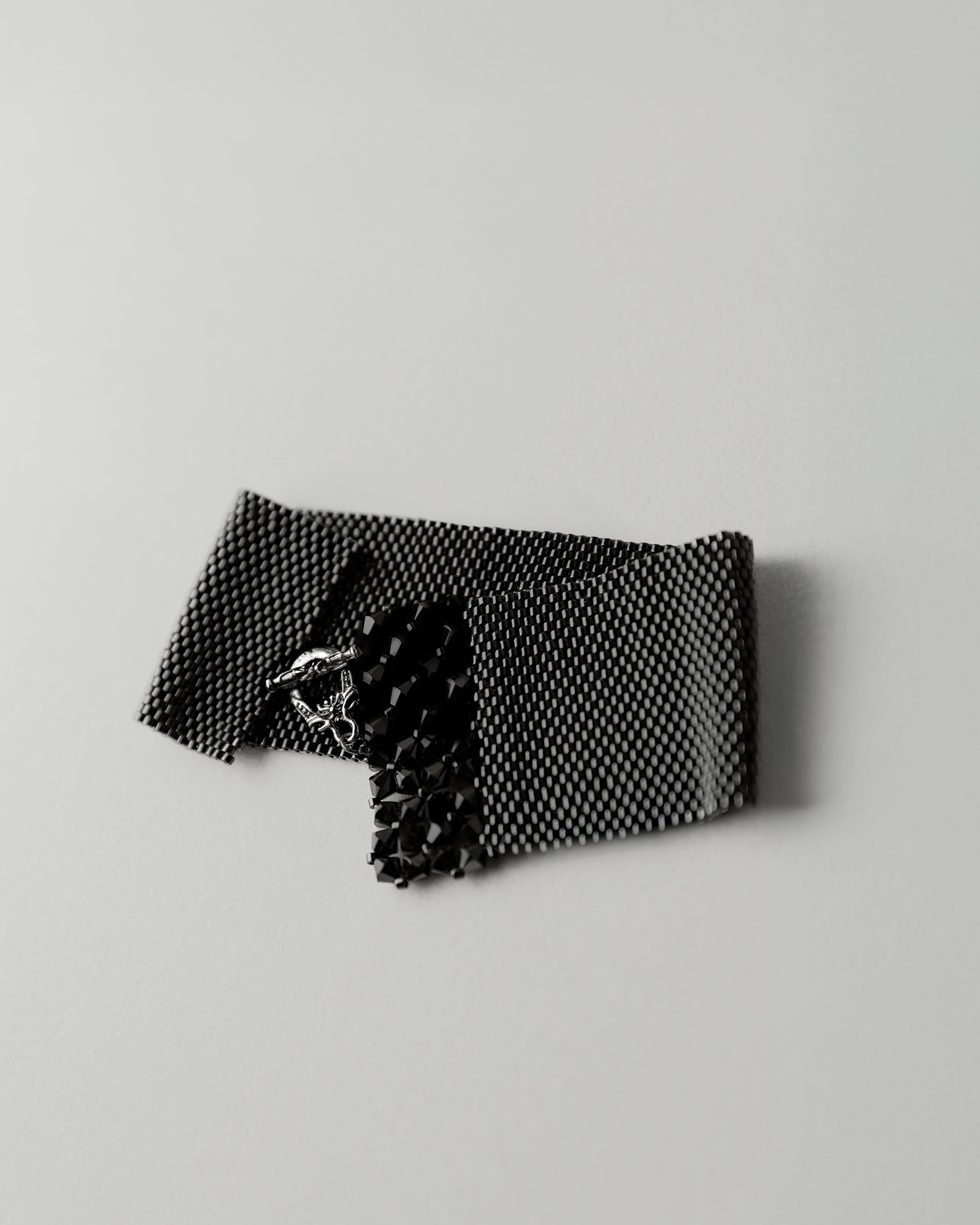 Black textured fabric on a light gray background