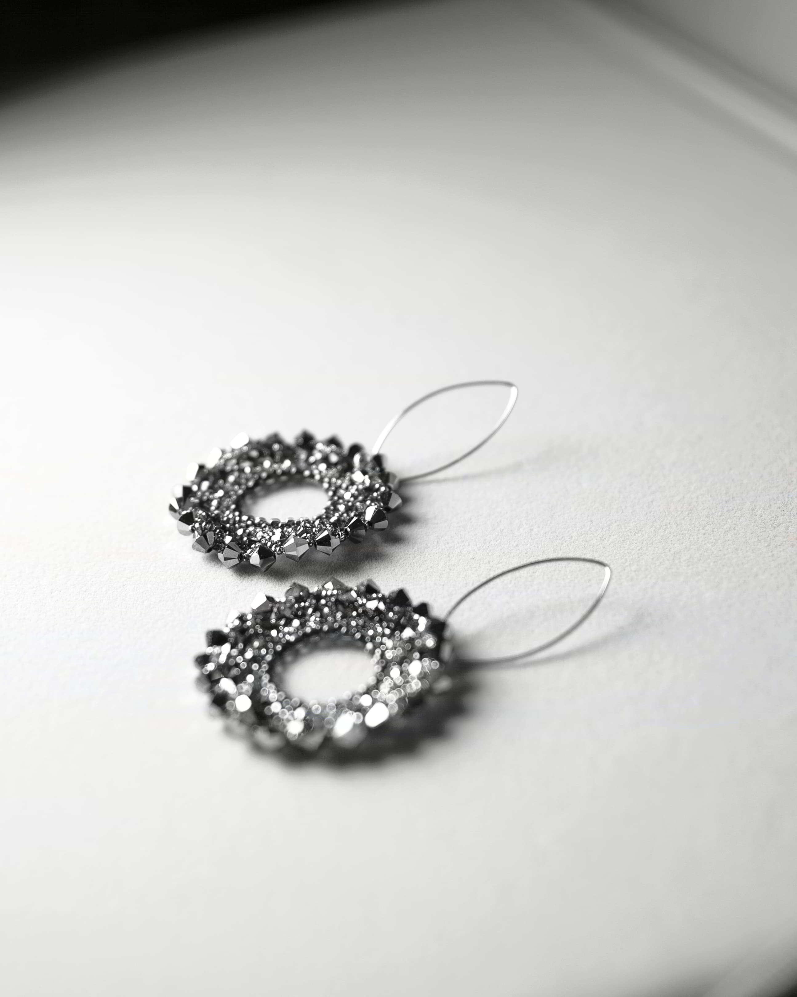 Pair of silver hoop earrings on a light background