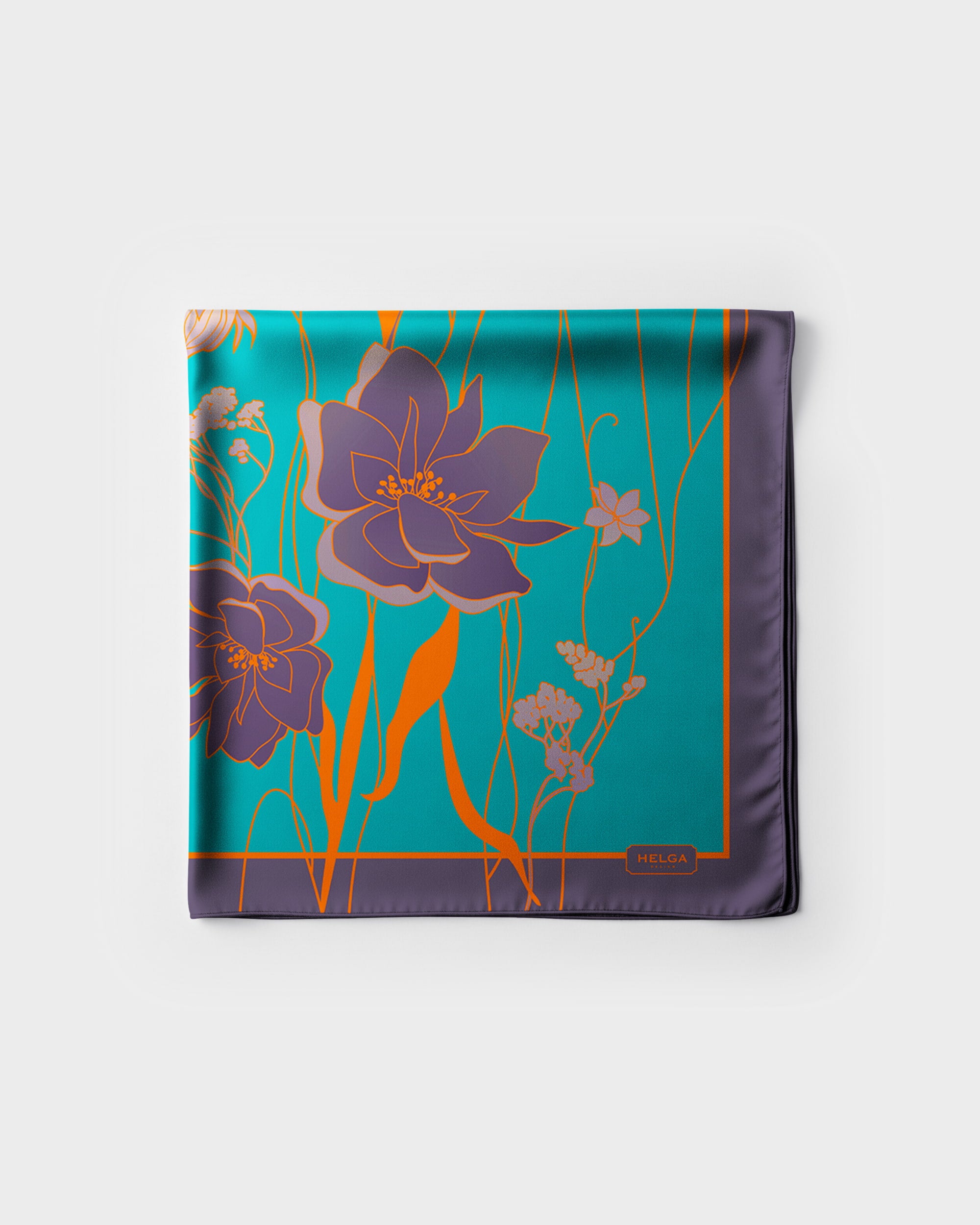 Floral patterned square silk scarf on a white background