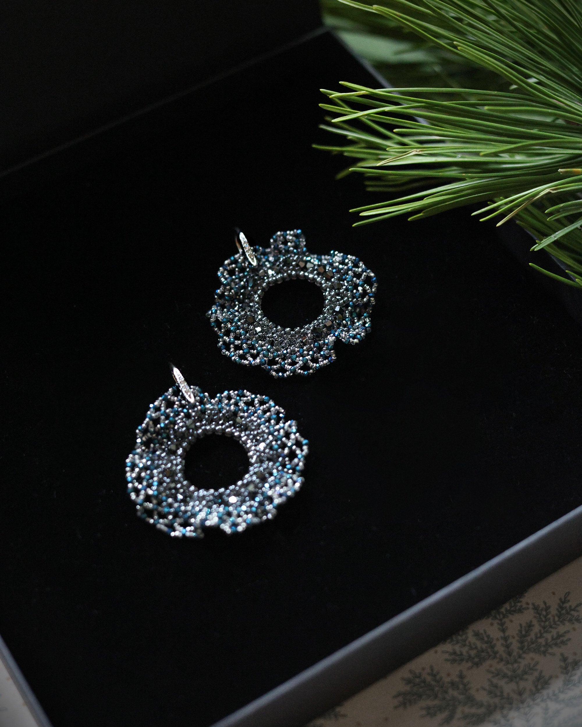 Round beaded earrings with blue crystals